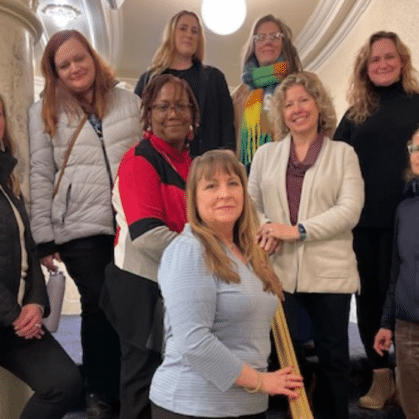 A group of mixed women standing on stairsteps